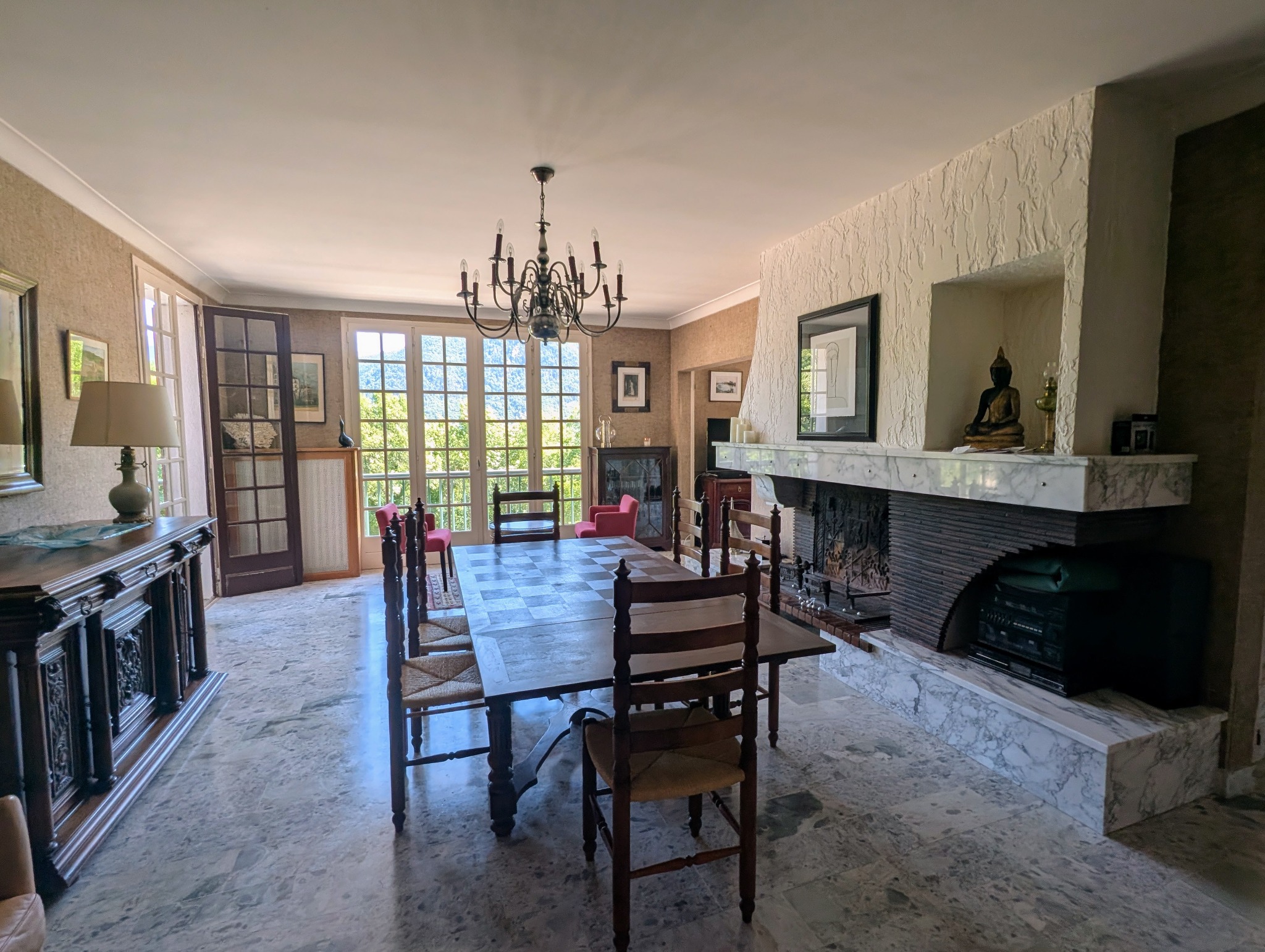 Autre vue de la grande pièce avec la table familiale et la cheminée